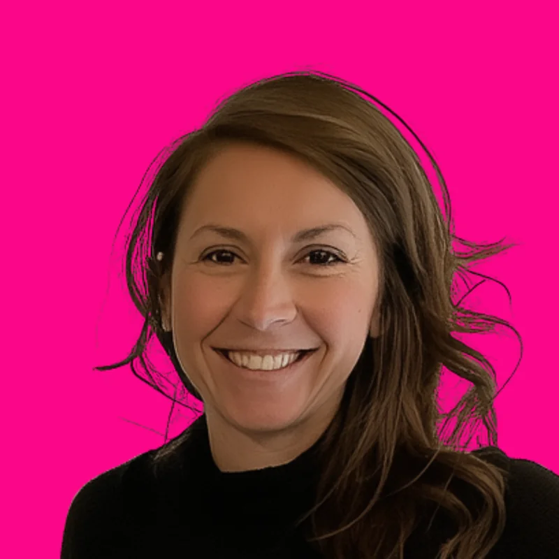 Portrait of Ilyssa Berger Wilson, smiling, against a bright pink background